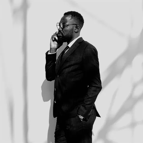 A man talks on a phone.