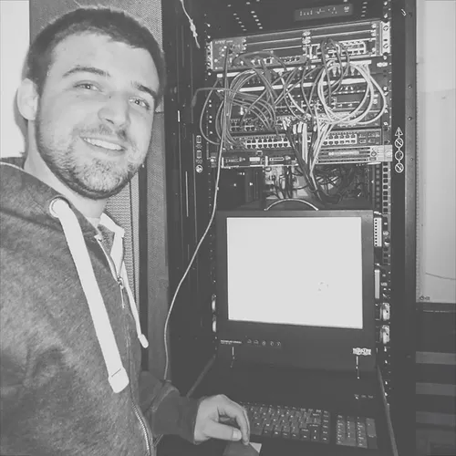 Myntex CEO Geoff Green works on a server rack during the early years of the company.